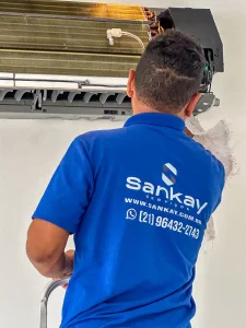 Técnico secando unidade evaporadora de ar condicionado split durante manutenção